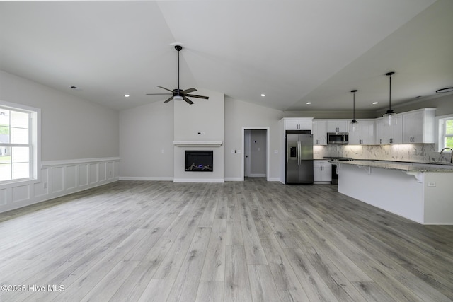 682 Crump Farm Rd, New Bern, NC 28562 - unfurnished living room featuring recessed lighting, ceiling fan, light wood-style flooring, and vaulted ceiling