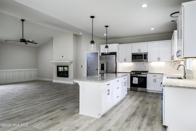 682 Crump Farm Rd, New Bern, NC 28562 - kitchen with white cabinetry, a sink, stainless steel appliances, a center island, and light stone countertops