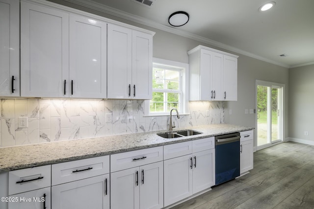 682 Crump Farm Rd, New Bern, NC 28562 - kitchen with light wood finished floors, a sink, a healthy amount of sunlight, dishwashing machine, and white cabinetry