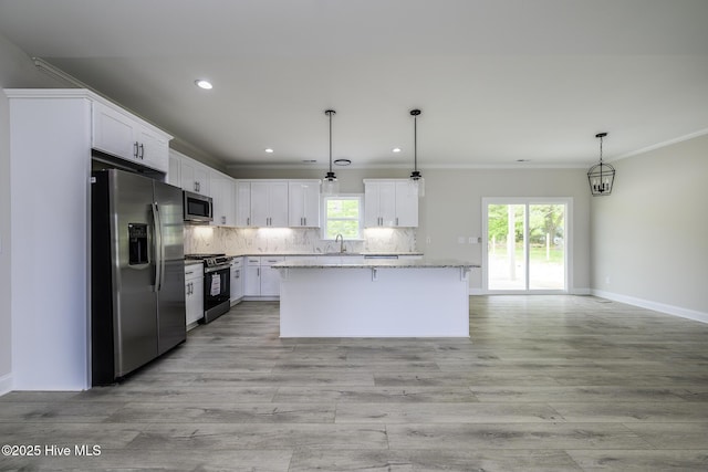 682 Crump Farm Rd, New Bern, NC 28562 - kitchen with a sink, crown molding, a center island, backsplash, and appliances with stainless steel finishes