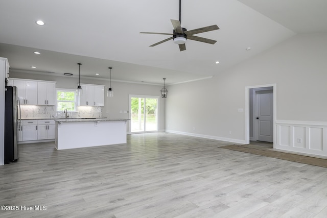 682 Crump Farm Rd, New Bern, NC 28562 - unfurnished living room featuring recessed lighting, ceiling fan, light wood finished floors, a sink, and lofted ceiling