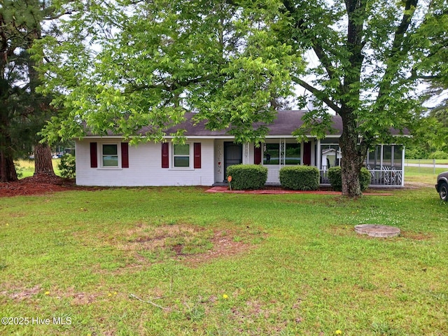 ranch-style home with a sunroom and a front yard