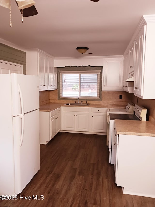 kitchen featuring dark wood-type flooring, sink, tasteful backsplash, white appliances, and white cabinets