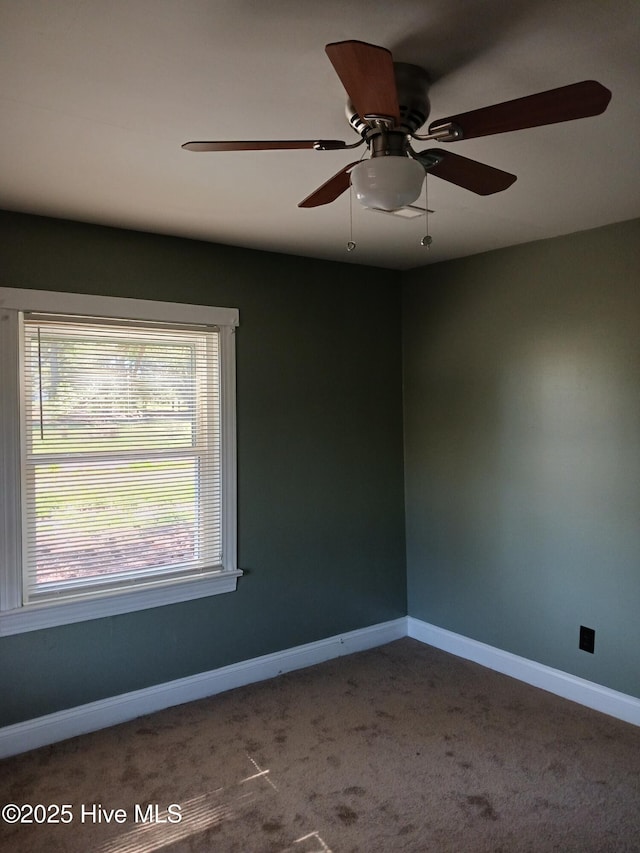 carpeted empty room featuring ceiling fan