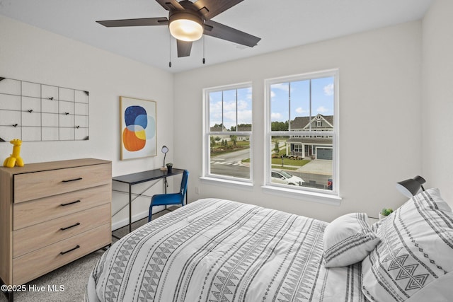 bedroom featuring ceiling fan and carpet