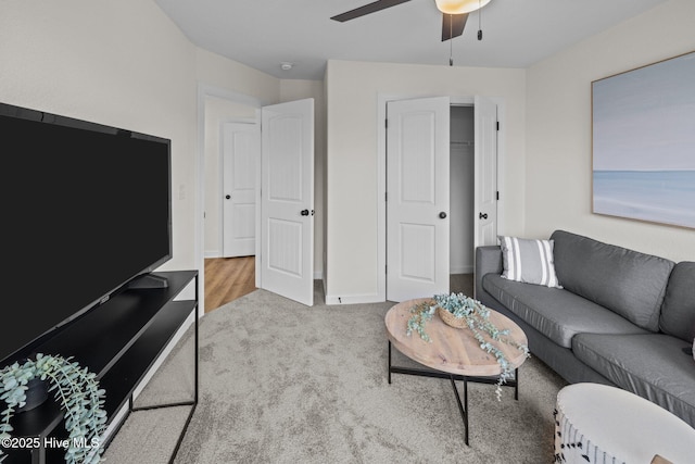 carpeted living room featuring ceiling fan