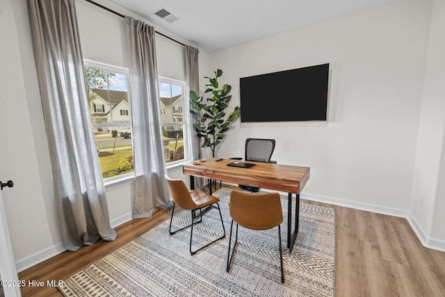 office space with light hardwood / wood-style floors