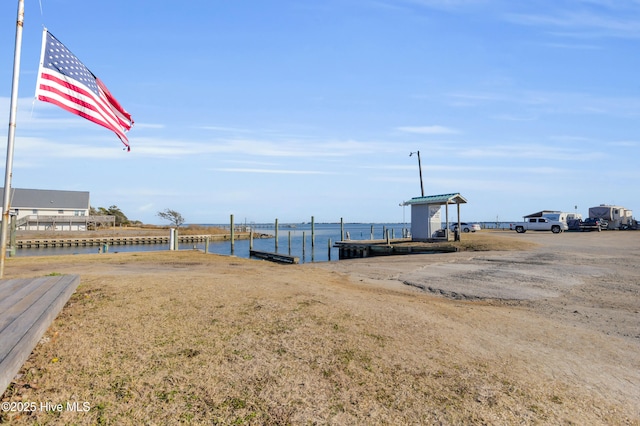 view of yard featuring a boat dock and a water view