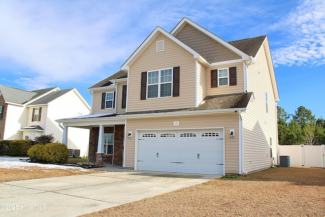 view of front of house with a garage and central AC