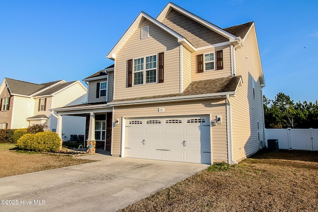 craftsman-style house with central AC unit, concrete driveway, an attached garage, a gate, and fence