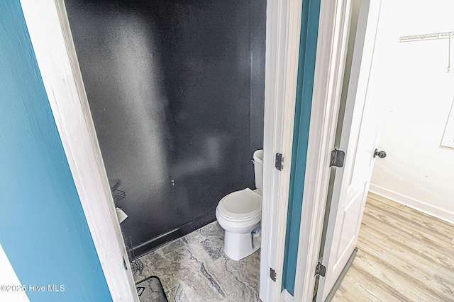 bathroom featuring toilet and wood finished floors