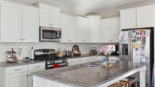 kitchen featuring white cabinetry, tasteful backsplash, and appliances with stainless steel finishes