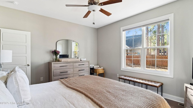 bedroom featuring ceiling fan, radiator heating unit, and dark hardwood / wood-style flooring