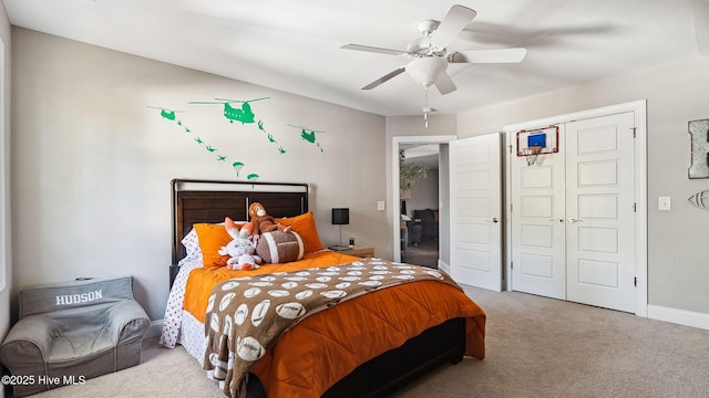 carpeted bedroom with a closet and ceiling fan