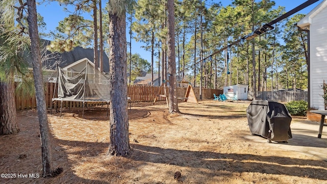 view of yard with a trampoline