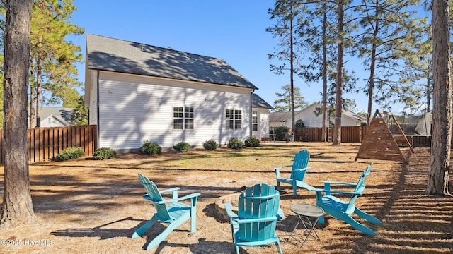 back of house with an outdoor fire pit