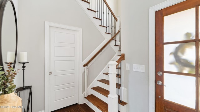 staircase with hardwood / wood-style floors