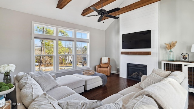 living room with vaulted ceiling with beams, dark wood-type flooring, a fireplace, and ceiling fan