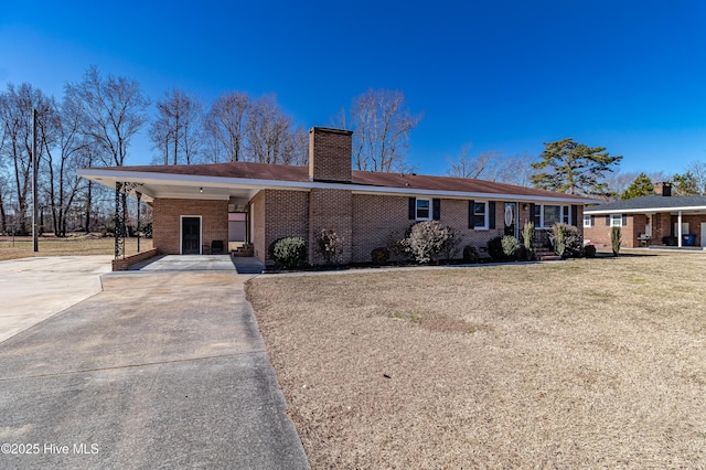 single story home featuring a carport and a front lawn