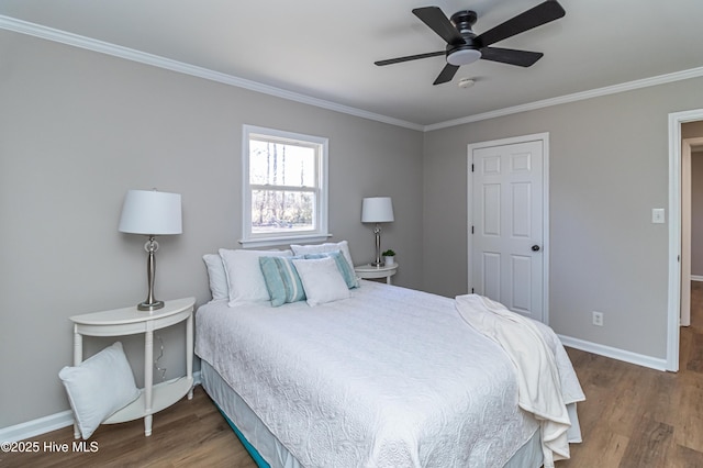 bedroom featuring crown molding, dark wood-type flooring, and ceiling fan