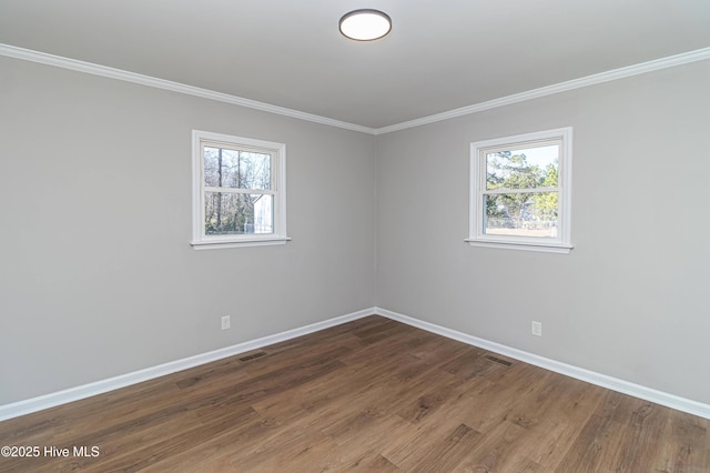 spare room with crown molding and dark hardwood / wood-style flooring