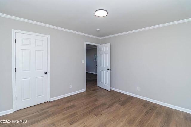 unfurnished bedroom with ornamental molding and dark hardwood / wood-style flooring