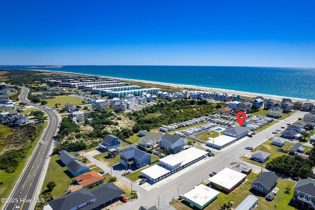 drone / aerial view featuring a water view and a beach view