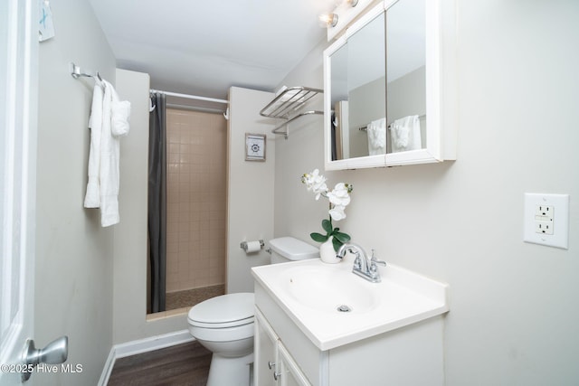 bathroom with a shower with curtain, vanity, toilet, and hardwood / wood-style flooring