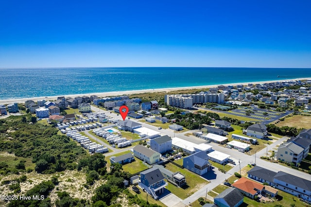 drone / aerial view featuring a water view and a view of the beach