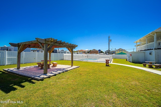 view of yard with a fenced in pool and a pergola