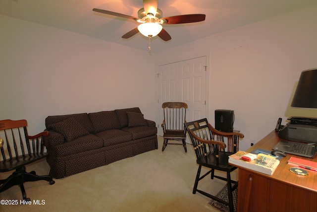 carpeted home office featuring ceiling fan