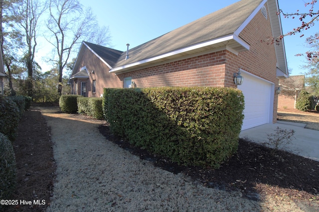 view of side of home with a garage