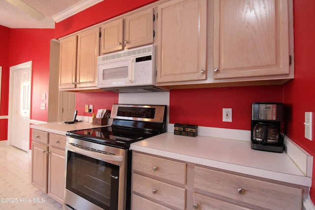 kitchen featuring stainless steel electric stove, a textured ceiling, and light brown cabinetry