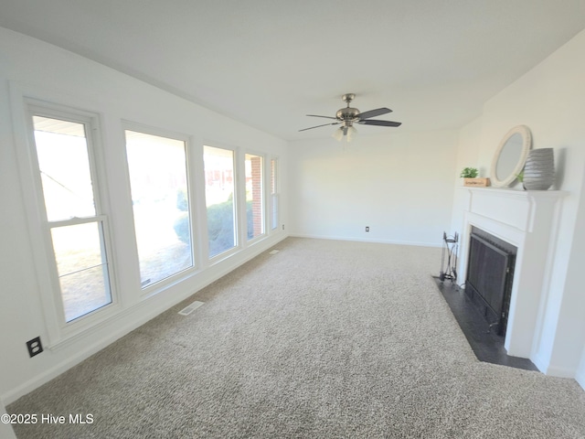 living room featuring ceiling fan and dark carpet