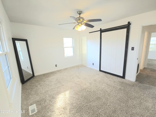 unfurnished bedroom featuring ceiling fan and multiple windows