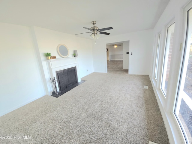 unfurnished living room featuring ceiling fan and carpet