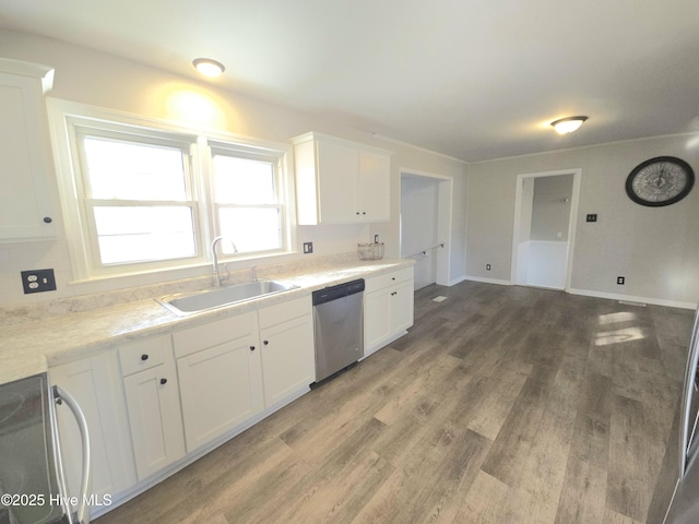 kitchen featuring dishwasher, sink, white cabinetry, hardwood / wood-style floors, and range