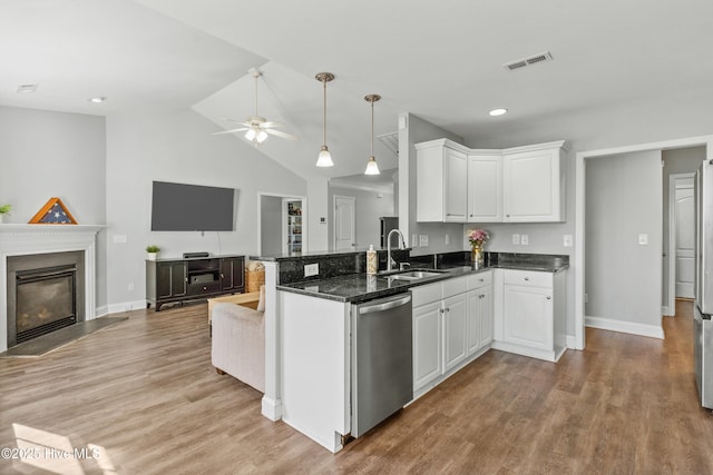 kitchen with white cabinets, dishwasher, kitchen peninsula, and sink