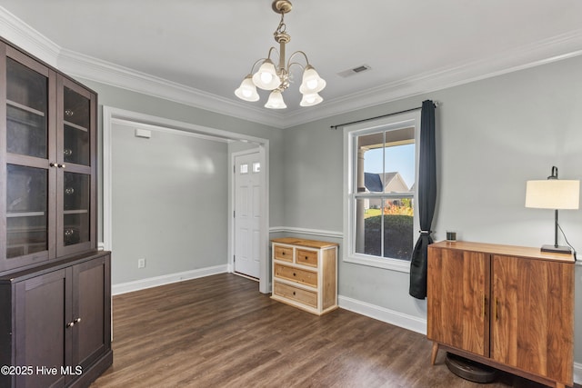 interior space featuring dark wood-type flooring, ornamental molding, and a chandelier