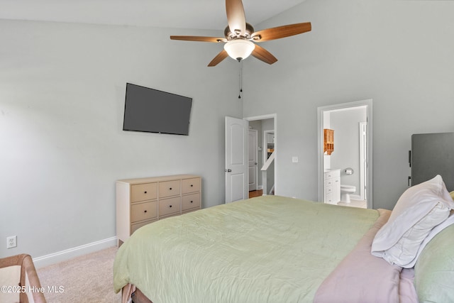 bedroom featuring ceiling fan, high vaulted ceiling, connected bathroom, and light carpet