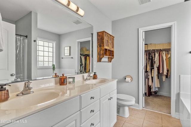 bathroom featuring a tub, toilet, tile patterned floors, and vanity