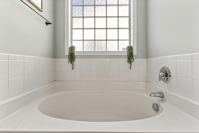 bathroom with plenty of natural light and a bathtub