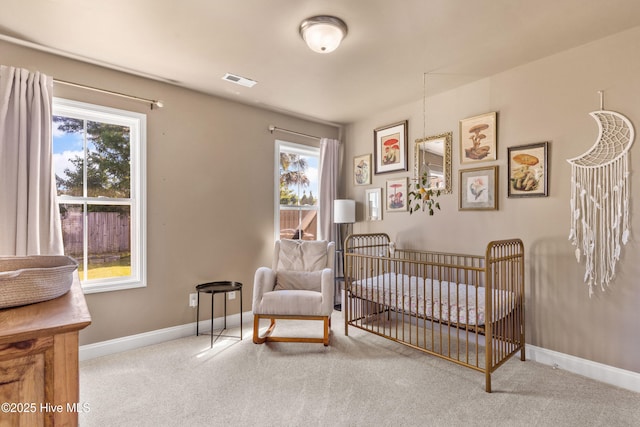 bedroom with light colored carpet and a crib