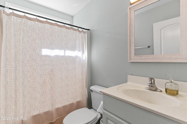 full bathroom with toilet, shower / bath combination with curtain, and vanity