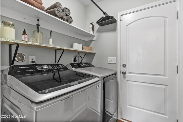 clothes washing area featuring washer and clothes dryer