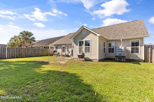 back of house featuring a yard