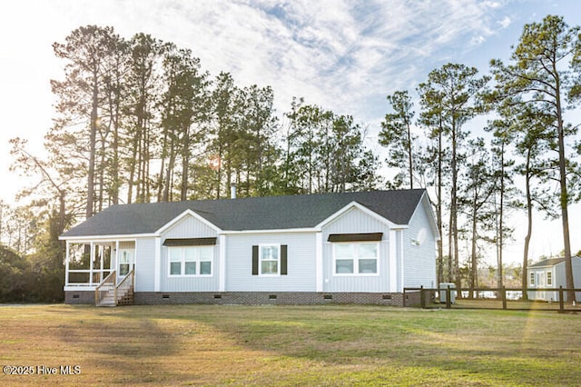 rear view of property featuring a yard