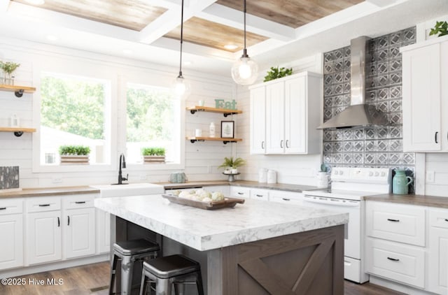 kitchen with white electric range oven, dark hardwood / wood-style flooring, wall chimney range hood, and white cabinetry