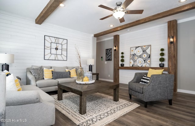 living room featuring wood walls, dark hardwood / wood-style floors, beam ceiling, and ceiling fan