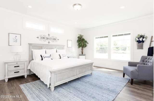 bedroom featuring hardwood / wood-style floors and crown molding